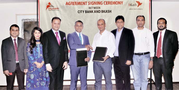 Sheikh Mohammad Maroof, Additional Managing Director of City Bank and Moinuddin Mohammed Rahgir, Chief Financial Officer of bKash, exchanging documents after signing an agreement to make automated payments to its nationwide distributors via CityLive inter