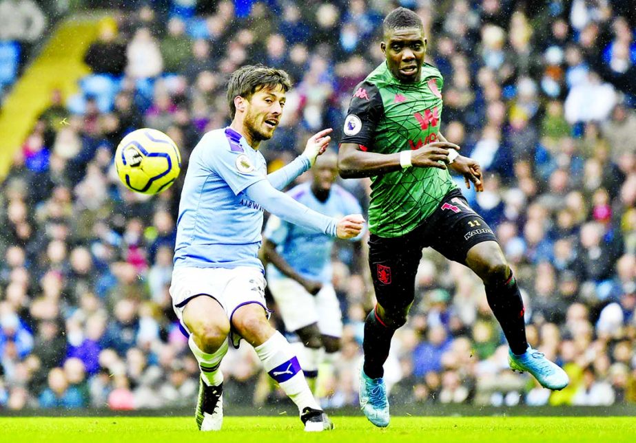 Manchester City's David Silva (left) and Aston Villa's Marvelous Nakamba challenge for the ball during the English Premier League soccer match between Manchester City and Aston Villa at Etihad stadium in Manchester, England on Saturday.