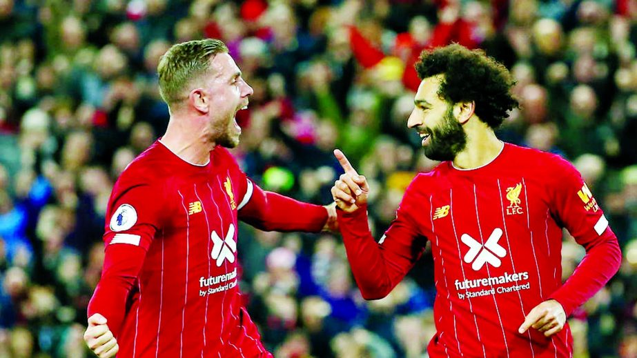 Mohamed Salah (right) claimed the 50th Anfield goal of his Liverpool career from the penalty spot as the Premier League leaders restored their six-point advantage at the top of the table after surviving a major scare against Tottenham on Sunday.