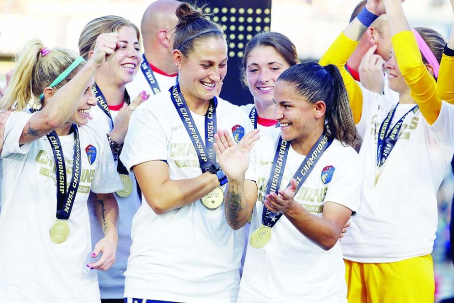 North Carolina Courage's Debinha (front right) is congratulated by teammates after being named the MVP of an NWSL championship soccer game against the Chicago Red Stars in Cary, N.C. on Sunday.