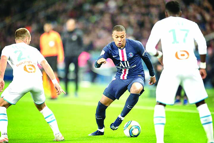 Kylian Mbappe (center) of Paris Saint-Germain vies with Valere Germain (left) and Bouna Sarr of Olympique of Marseille during the Ligue 1 match at the Parc des Princes in Paris, France on Sunday.