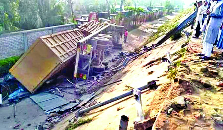 A big lorry being overturned on Dhaka-Chattogram Highway bridge and skidded into the ditch at Sitakunda leaving two people dead on Monday.