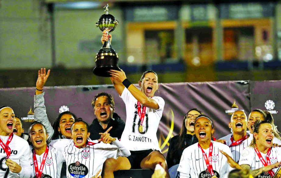 Gabriela Zanotti of Brazil's Corinthians holds up her team's trophy after winning the Women's Copa Libertadores soccer tournament following their 2-0 victory over Brazil's Ferroviaria at Atahualpa Stadium in Quito, Ecuador on Monday.