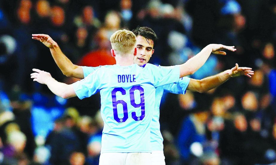 Manchester City's Tommy Doyle and Eric Garcia celebrate after the match against Southampton in Manchester, Britain on Tuesday.