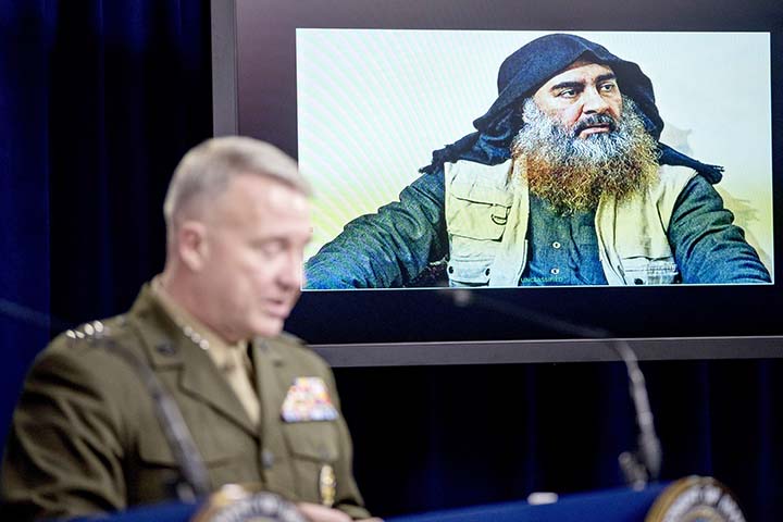 Abu Bakr al-Baghdadi is displayed on a monitor as U.S. Central Command Commander Marine Gen. Kenneth McKenzie at a joint press briefing at the Pentagon in Washington on Wednesday on the Abu Bakr al-Baghdadi raid.