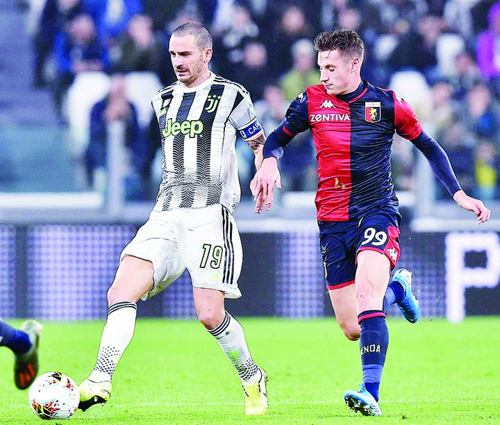 Juventus' Leonardo Bonucci and Genoa's Andrea Pinamonti (right) go for the ball during the Italian Serie A soccer match between Juventus and Genoa at the Allianz stadium in Turin, Italy on Wednesday.