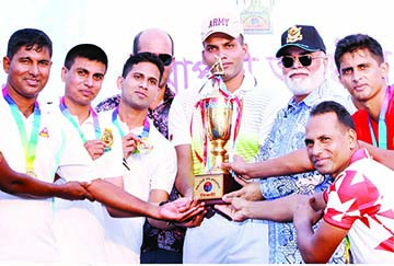 Air Officer Commanding of BAF Base Bashar Air Vice Marshal Md Shafiqul Alam handing over the trophy to Bangladesh Army Hockey team, which emerged as the champions in the Inter-Service Hockey Competition at the Maulana Bhashani National Hockey Stadium o