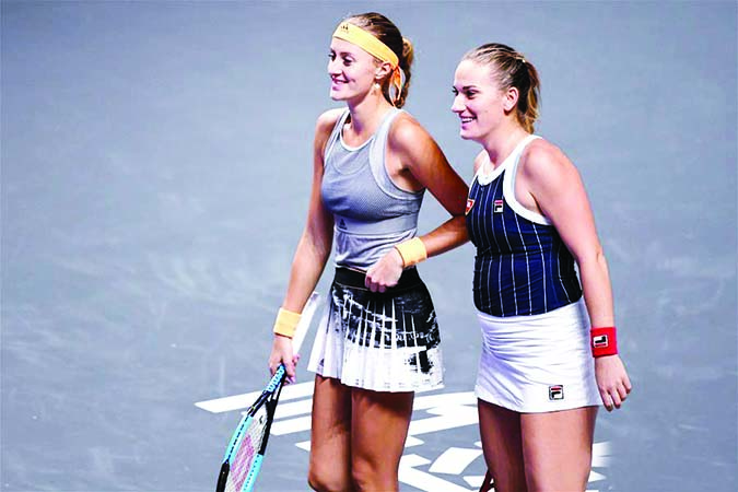 Timea Babos (right) of Hungary and Kristina Mladenovic of France react during the doubles round robin match against Anna-Lena Groenefeld of Germany and Demi Schuurs of the Netherlands at the WTA Finals Tennis Tournament in Shenzhen, south