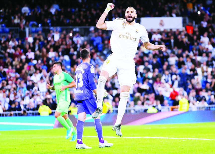 Real Madrid's Karim Benzema celebrates scoring their fourth goal from the penalty spot during the match against LeganÃ©s in Madrid, Spain on Wednesday.