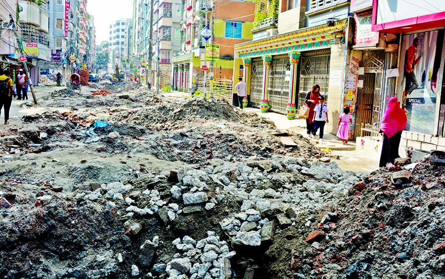 Mud and soil being piled up on many city roads at digging spots where the City Corporations are setting up underground pipes to mitigate the waterlogging crisis, creating huge inconveniences for the residents. This photo was taken from the South Banasree