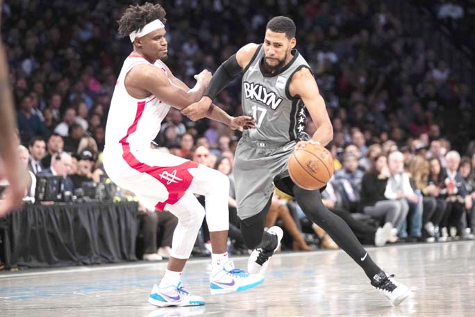 Brooklyn Nets guard Garrett Temple (17) drives to the basket against Houston Rockets forward Danuel House Jr. during the second half of an NBA basketball game in New York on Friday. The Nets won 123-116.
