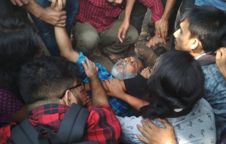 A faculty member seen lying on the ground during a clash in Jahangirnagar University on Tuesday, November 5, 2019 Dhaka Tribune