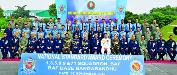 President M Abdul Hamid poses for a photo session with the Squadron officials and air force members at the National Standard Award Ceremony of the 1, 3,5,8,9 and 71 Squadrons of BAF at its Bangabandhu Base in Dhaka Cantonment on Tuesday. Press Wing, Bang