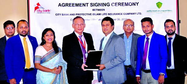 Md. Zafrul Hasan, Head of Digital Finance Services of City Bank Limited and Dr. Kishore Biswas, DMD of Protective Islami Life Insurance Limited, exchanging documents after signing an agreement at the bank's head office in the city recently. Arifur Rahman