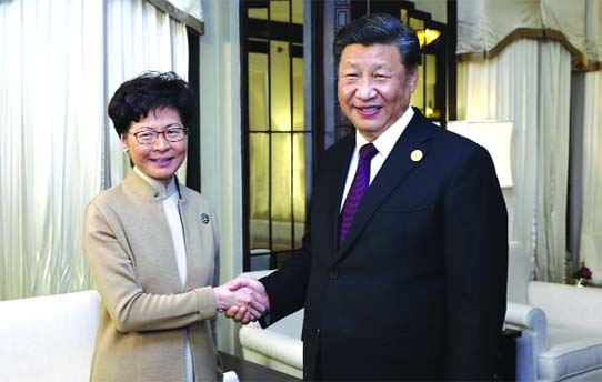 Chinese President Xi Jinping poses with Hong Kong Chief Executive Carrie Lam for a photo during a meeting in Shanghai, China. Lam is here for the second China International Import Expo (CIIE).