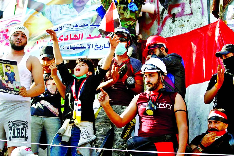 Iraqi demonstrators chant slogans during an ongoing anti-government protest in Baghdad on November 5.