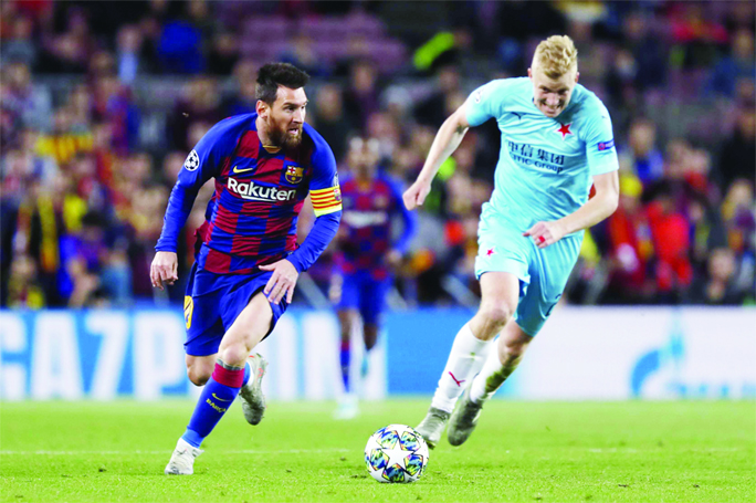 Barcelona's Lionel Messi (left) controls the ball during a Champions League Group F soccer match between Barcelona and Slavia Praha at Camp Nou stadium in Barcelona, Spain on Tuesday.