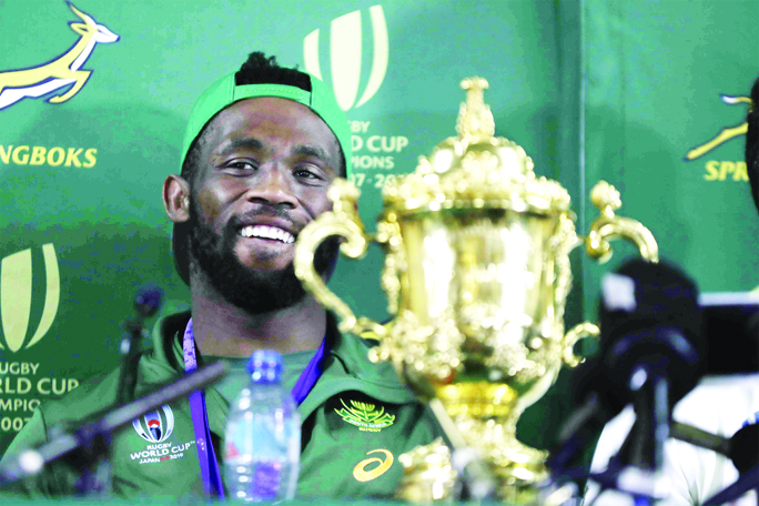 South African rugby captain Siya Kolisi with the Web Ellis trophy attends a news conference on the team's arrival back on home soil at the O.R. Tambo Airport in Johannesburg on Tuesday. South Africa beat England in the Rugby World Cup final Saturday 32-1