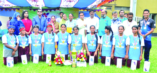 Gazirchat AM High School & College Rugby team, the champions in the 4th Walton Under-17 Women's College Rugby Competition with the guests and officials of Bangladesh Rugby Union pose for a photo session at Sultana Kamal Women's Sports Complex in the