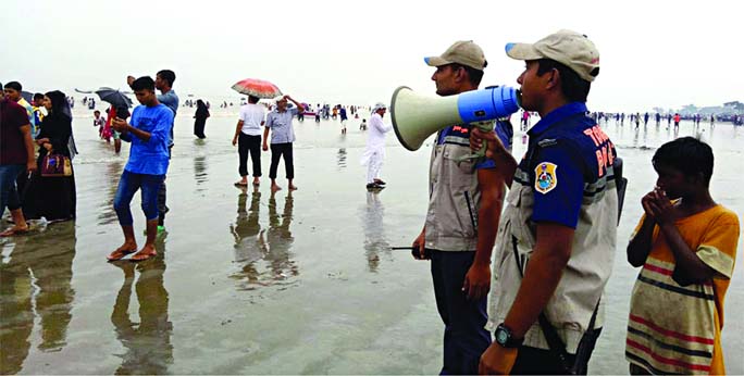 Kuakata Tourist Police and Maritime Police engaged in warning tourists and also commoners for their movement as the cyclone Bulbul may hit Bangladesh any time. The snap was taken from Kuakata sea beach on Friday.