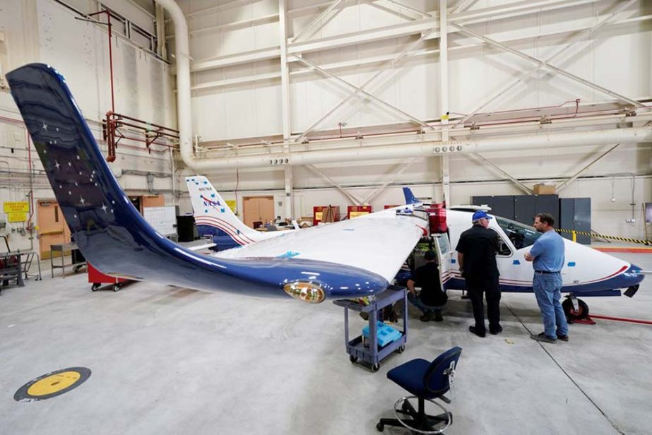 Technicians work on NASA's first all-electric plane, the X-57 Maxwell, at NASA's Armstrong Flight Research Center at Edwards Air Force Base, California, US on Friday.