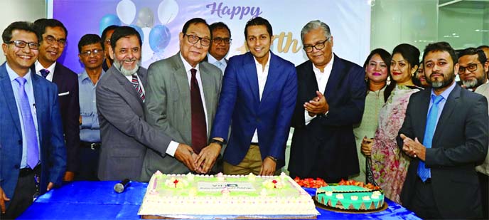 A. Rouf Chowdhury, Chairman of Bank Asia Limited and ERA-InfoTech Limited, celebrating its 17th anniversary by cutting a cake at its office in the city recently. Mihir Kanti Majumdar, Chairman, Palli Sanchay Bank, Syed Almas Kabir, President of Bangladesh