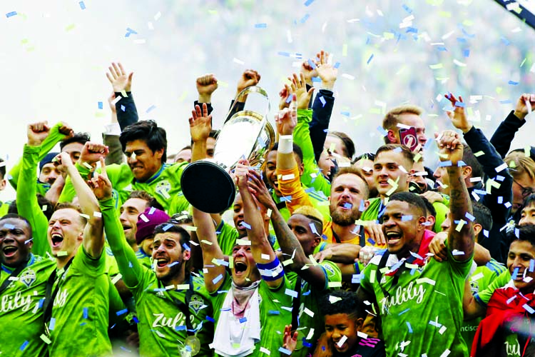 The Seattle Sounders celebrate after winning the MLS Cup soccer match 3-1 over Toronto FC on Sunday.