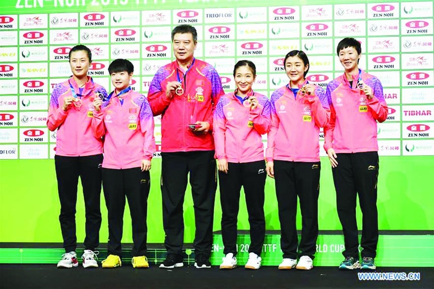 Coach Li Sun (3rd left) and players of team China pose on the podium during the awarding ceremony after the the women's final between China and Japan at the 2019 ITTF Team World Cup in Tokyo, Japan on Sunday.