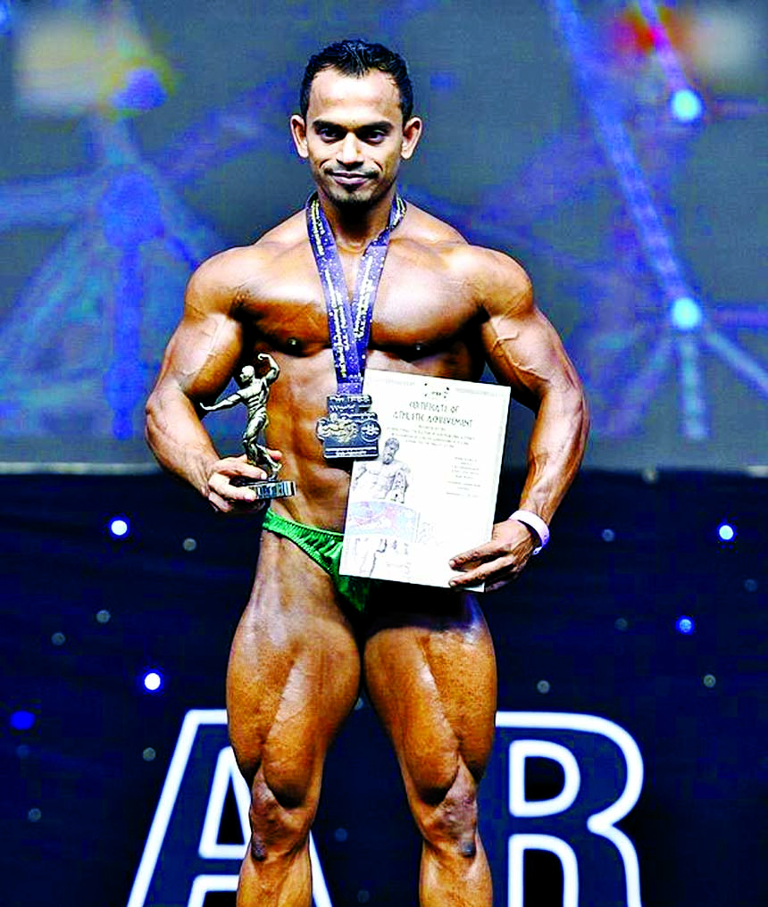 Mister Bangladesh Robin poses with his silver medal, award and certificate after he becoming second in the 60 kg category of IFBB 73rd World Bodybuilding Championship at Zayed Sports Complex in Al-Fujairah, United Arab Emirates recently.