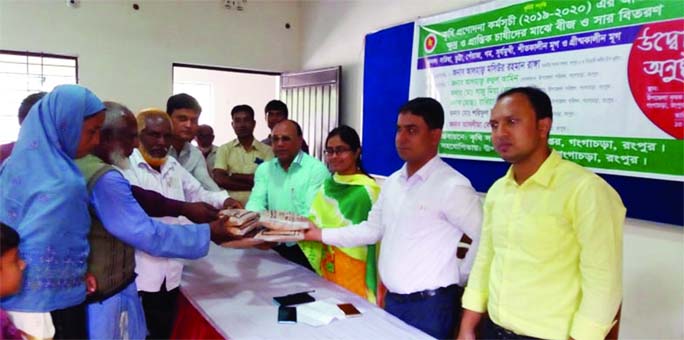 GANGACHARA (Rangpur): Saju Ahmed Lal, UNO distributing free seeds and fertilizer among the farmers organised by Agriculture Extension Department on Tuesday.