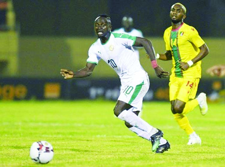 Sadio Mane (10) from Senegal, runs with the ball in front of a Congolese player at the Lat-Dior stadium in Thies, Senegal on Wednesday during a qualifying game ahead of the 2021 Africa Cup of Nations (CAF).