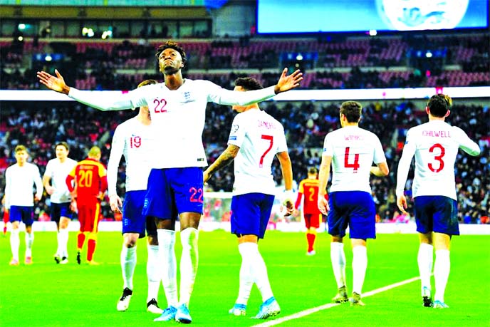 England's striker Tammy Abraham celebrates after scoring their seventh goal during the UEFA Euro 2020 qualifying first round Group A football match between England and Montenegro at Wembley Stadium in London on Thursday.