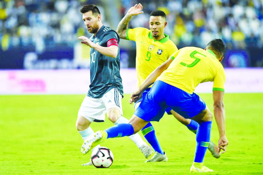 Argentina's Lionel Messi (left) fights for the ball with Brazil's Gabriel Jesus (center) and Brazil's Casimiro during a friendly soccer match between Brazil and Argentina at King Fahd stadium in Riyadh, Saudi Arabia on Friday.