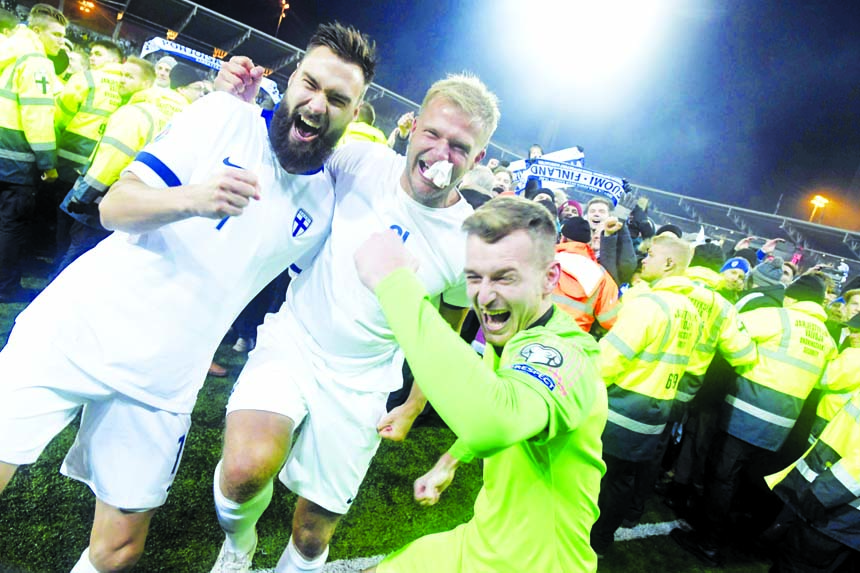 Finnish captain Tim Sparv ( left) celebrates with Paulus Arajuuri (center) and goalkeeper Lukas Hradecky after their victory in the Euro 2020 Group J qualifying soccer match between Finland and Liechtenstein in Helsinki, Finland on Friday.