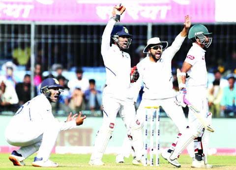 (From left) India's Mayank Agarwal, Wriddhiman Saha and Rohit Sharma appeal unsuccessfully for the wicket of Bangladesh's Taijul Islam (right) during the third day of first cricket Test match between India and Bangladesh in Indore, India on Saturday.