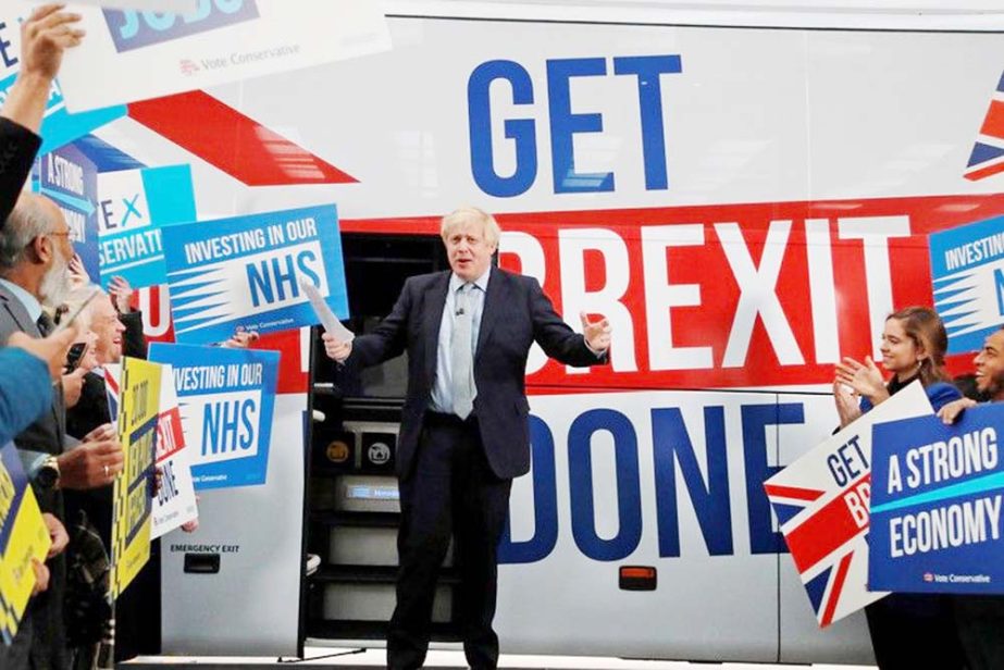 Britain's Prime Minister Boris Johnson addresses his supporters in front of the general election campaign trail bus in Manchester.