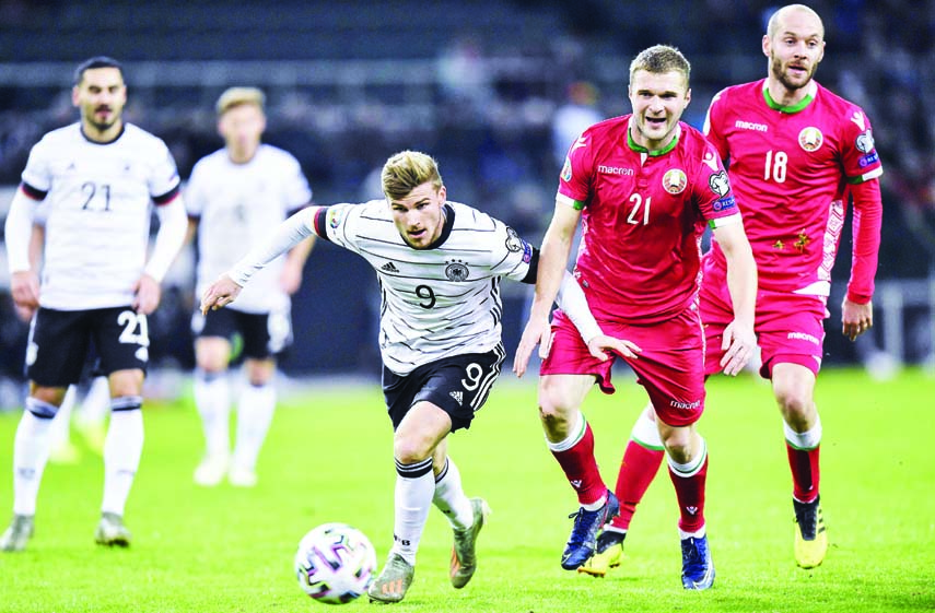 Germany's Timo Werner (left) and Belarus' Sergei Matvejchik challenge for the ball during the Euro 2020 group C qualifying soccer match between Germany and Belarus in Moenchengladbach, Germany on Saturday.