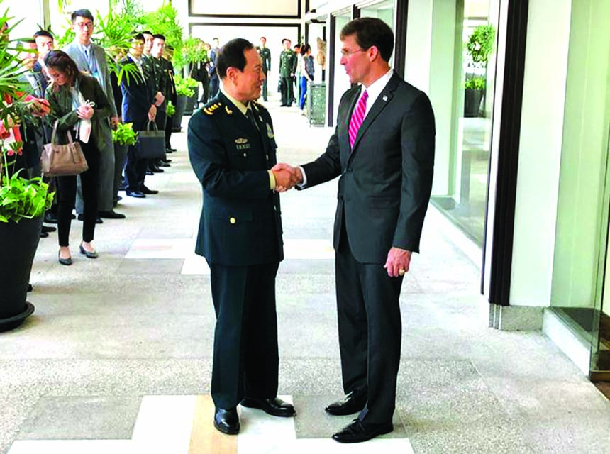 Chinese Defense Minister Wei Fenghe, (left) greets U.S. Defense Secretary Mark Esper in Bangkok on Monday.