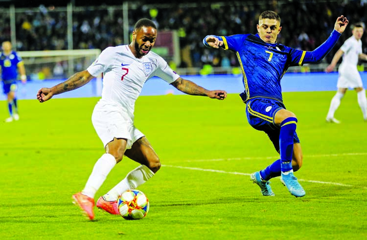 England's Raheem Sterling (left) and Kosovo's Milot Rashica challenge for the ball during the Euro 2020 group A qualifying soccer match between Kosovo and England at Fadil Vokrri stadium in Pristina, Kosovo on Sunday.