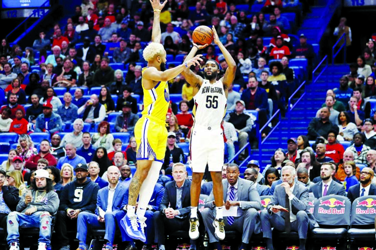 New Orleans Pelicans guard E'Twaun Moore (55) shoots over Golden State Warriors guard Ky Bowman (12) in the second half of an NBA basketball game in New Orleans on Sunday.