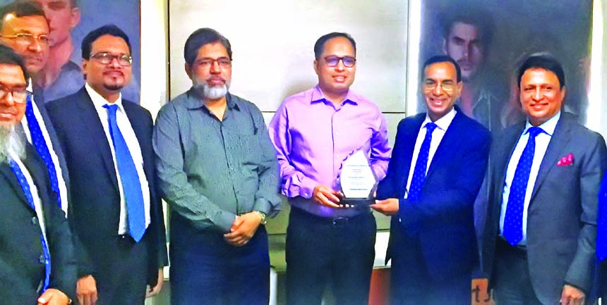 M Shahidul Islam, CEO of Shahjalal Islami Bank Limited, handing over a crest to Muzibur Rahman, Managing Director of Smart Jeans Limited,for being achieved the CIP status at the bank's head office in the city recently. Senior officials of the bank were a