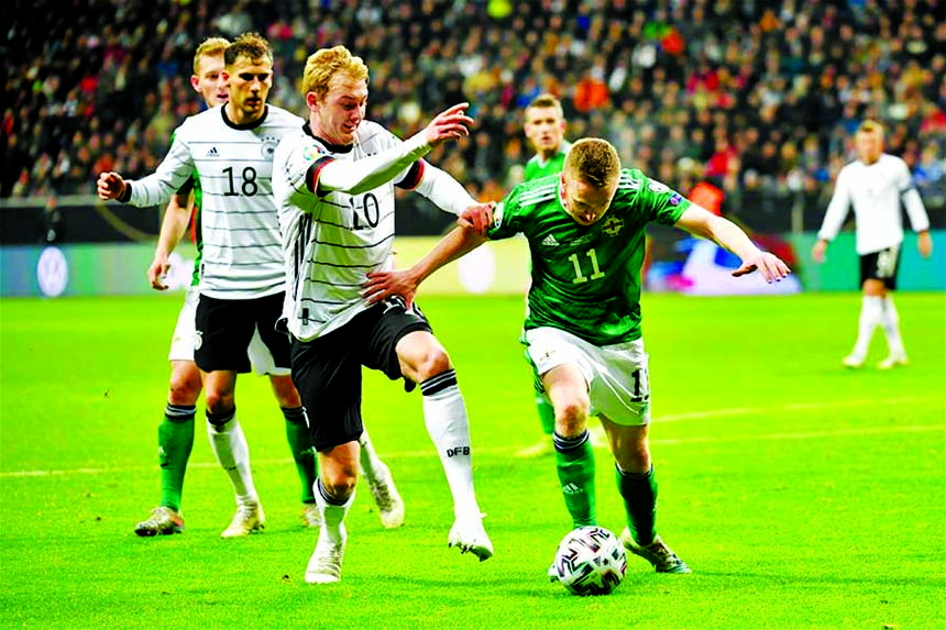 Julian Brandt (left, front) of Germany vies with Shane Ferguson of Northern Ireland during a UEFA Euro 2020 group C qualifying match between Germany and Northern Ireland in Frankfurt, Germany on Tuesday.