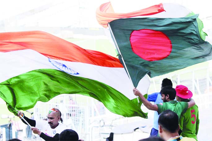 Indian and Bangladeshi cricket supporters cheer for their teams with their national flags ahead of their second cricket Test match between India and Bangladesh, in Kolkata, India on Thursday. The second and final game in the series is scheduled to be play