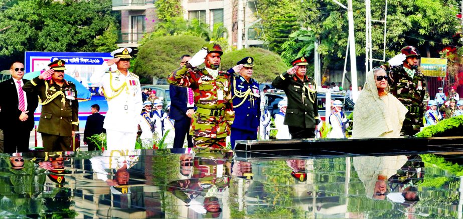 Prime Minister Sheikh Hasina stands in solemn silence as a mark of profound respect to the memories of the armed forces martyrs who made supreme sacrifices during the War of Liberation, after placing a wreath at the Shikha Anirban (flame eternal) in Dhaka