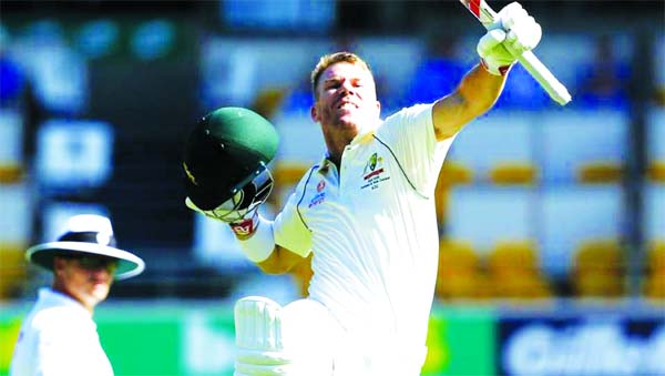 Australia's David Warner celebrates after scoring 100 runs during their cricket Test match against Pakistan in Brisbane on Friday.
