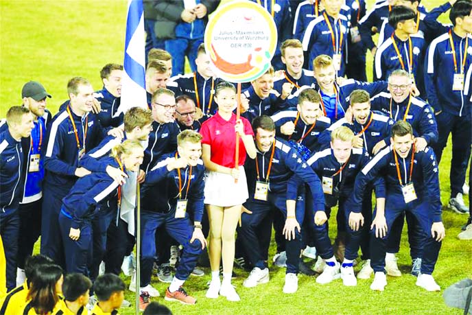 Team members of University of Wurzburg of Germany pose after the opening ceremony of the 2019 FISU University World Cup in Jinjiang, Southeast China's Fujian Province on Thursday.