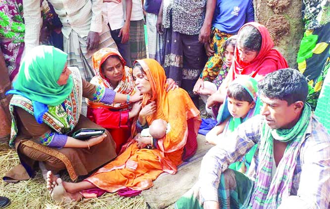 ISHWARGANJ(Mymensingh): Umme Rumana Toya, UNO, Ishwarganj Upazila consoling a mother of child who killed in a fire incident at Narayanpur Village on Thursday.