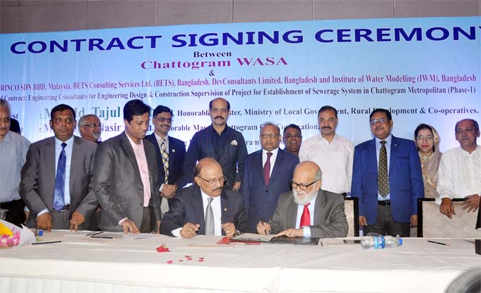 Minister for Local Government Tajul Islam MP signing a contract between Malaysian consultant IV IRENCO and CWASA at Radisson Blu Hotel yesterday.