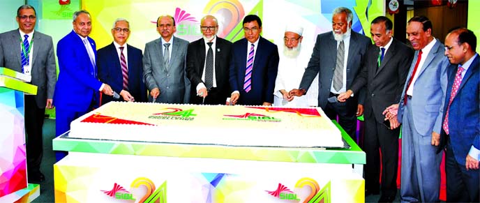 Professor Md. Anwarul Azim Arif, Chairman, Board of Directors of Social Islami Bank Limited, inaugurating its 24th anniversary programme by cutting a cake at the bank's corporate office in the city on Sunday. Md. Sayedur Rahman, Vice-Chairman, M. Kamal U