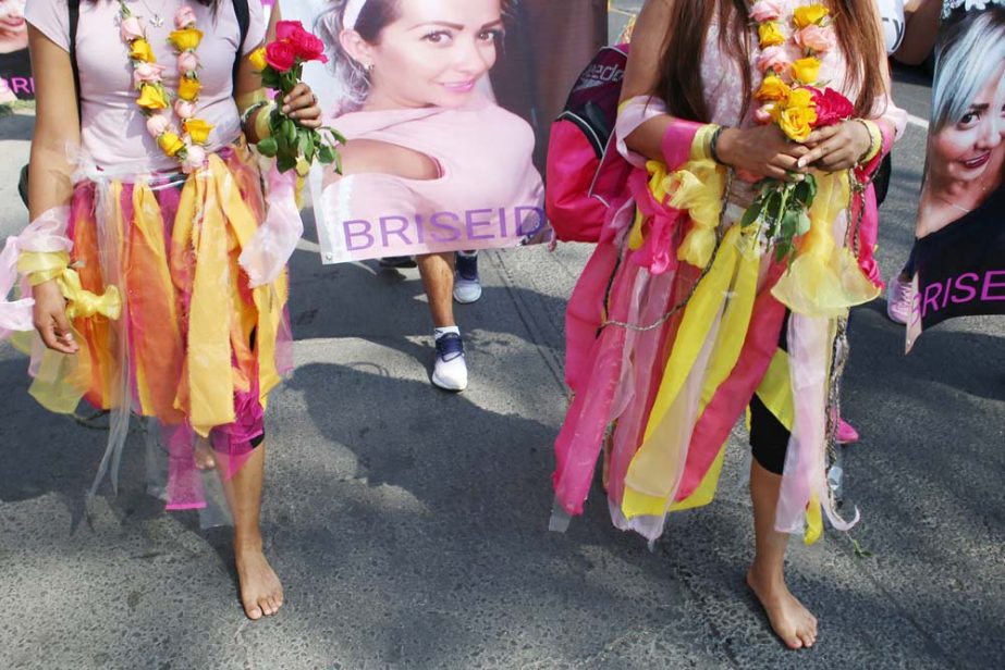 Women walk barefoot on asphalt, clothed in shreds of organza in pastel shades of pink and yellow, the favorite colors of murder victim Briseida Carreno, during a ceremony in her honor, in Ecatepec, a suburb of Mexico City on Saturday.